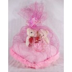Valentine Couple Teddy Bears sitting on a pink plush heart covered with net